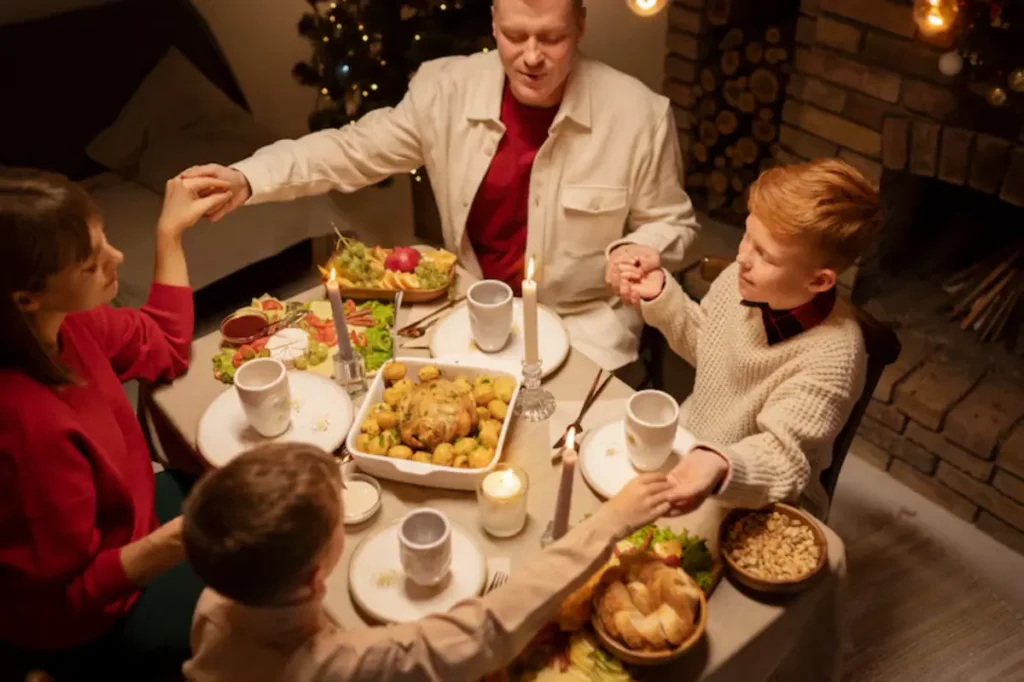 A cozy family dinner table adorned with festive dishes, candles, and holiday decor, capturing a warm moment of togetherness and celebration.